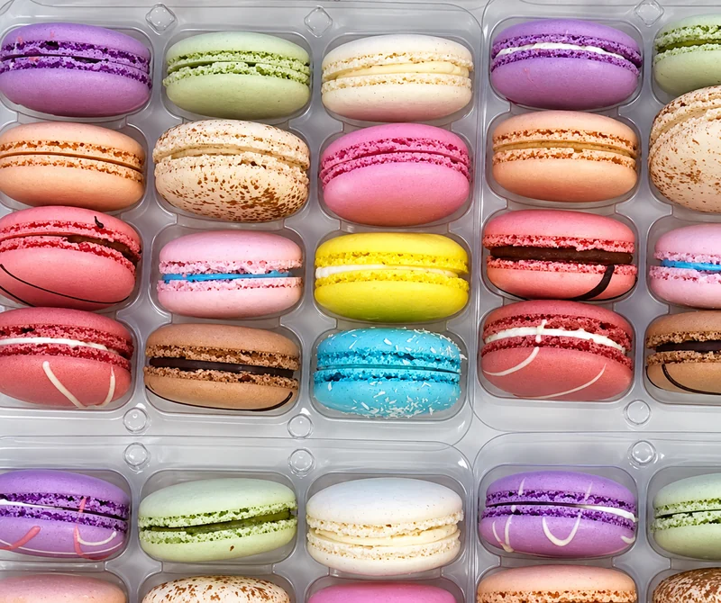 Colourful assortment of Coveted Cakes Premium Macarons arranged in trays